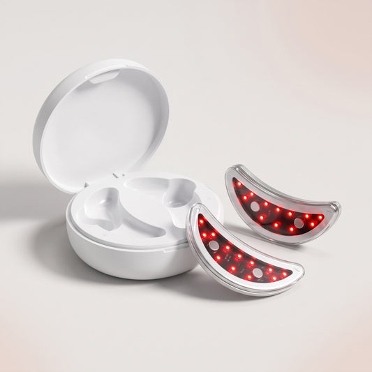 Open white charging case with two red light under-eye pads glowing beside it