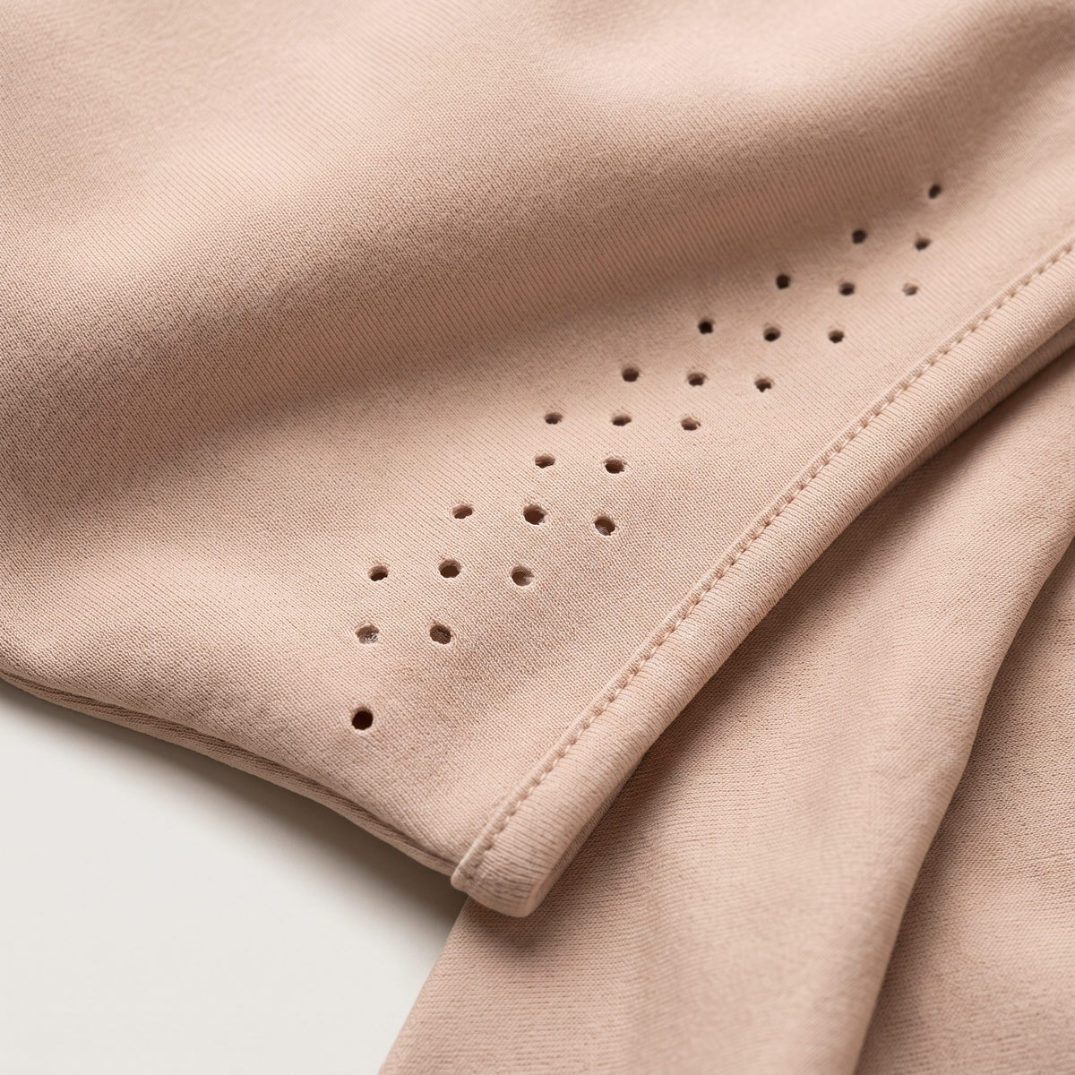 Close view of the wrap's stretch knit fabric and its ventilation perforations