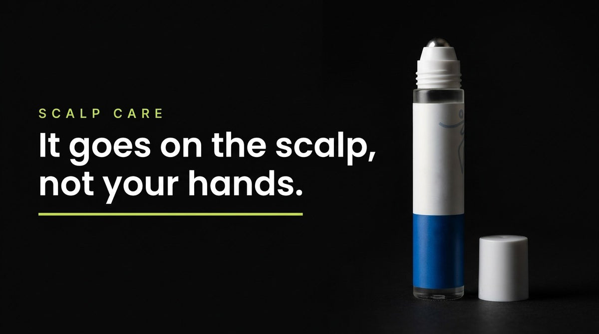 The scalp serum roll-on lit against a black background