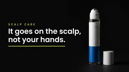 The scalp serum roll-on lit against a black background
