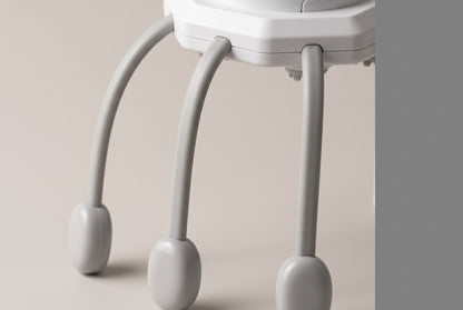 Close view of the scalp massager's legs against a pale background