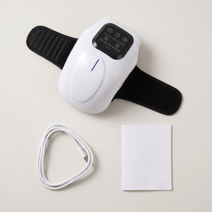 Flat lay of the joint massager, USB cable and user manual