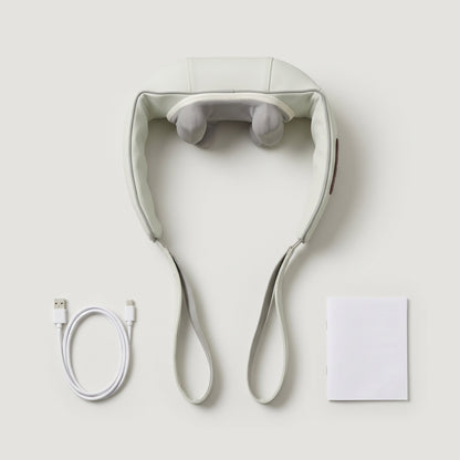 Flat lay of the neck and shoulder massager, USB charging cable and user manual