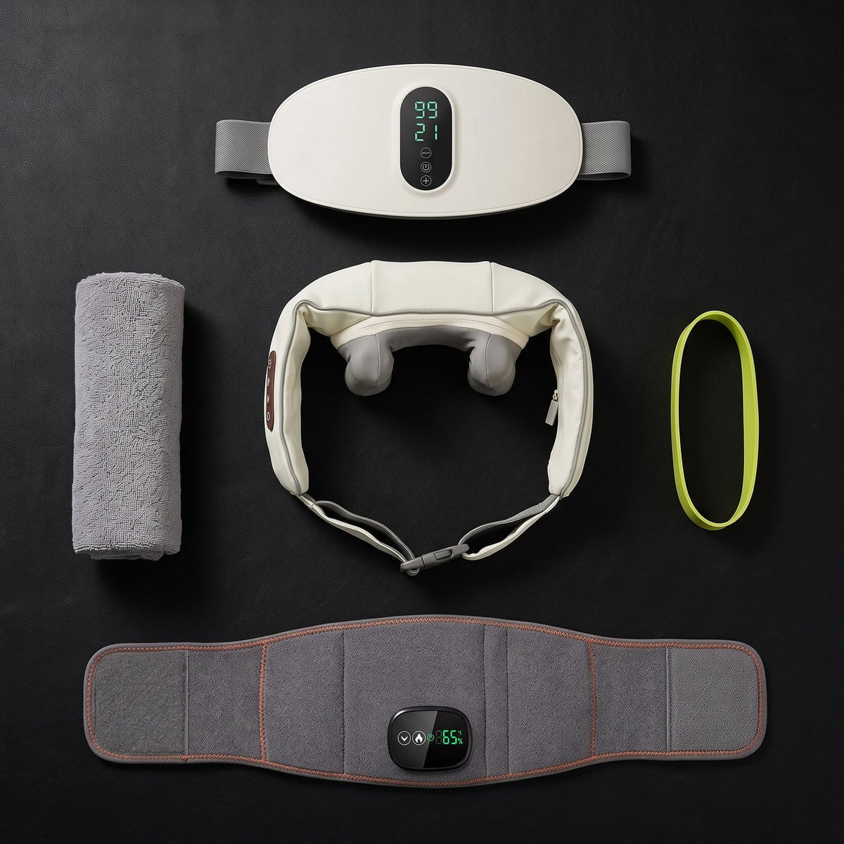 Flat lay of recovery gear: massage belts, neck massager, towel and resistance band