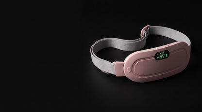 The pink USB heating belt lit against a black background
